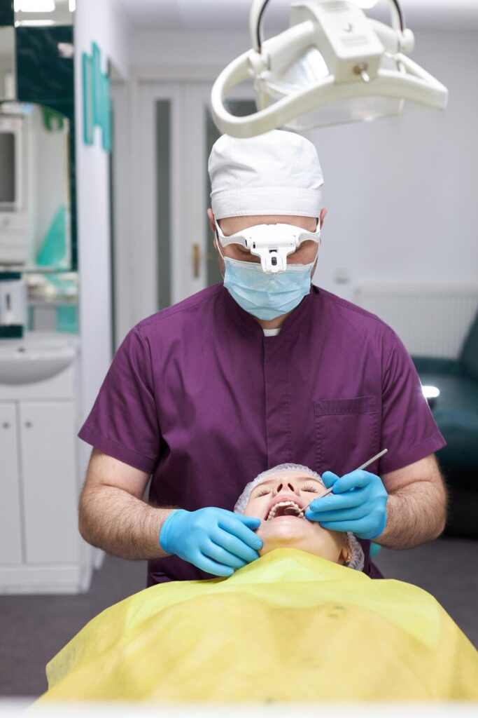 Experienced dentist hygienist using dental dental probe checks woman s teeth dentistry clinic 695242 1500